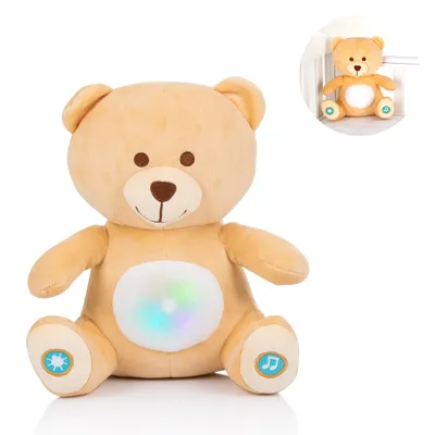 A plush teddy bear with lights on its belly and symbols on its paws, shown in a studio setting with a smaller inset image of the bear in a crib.