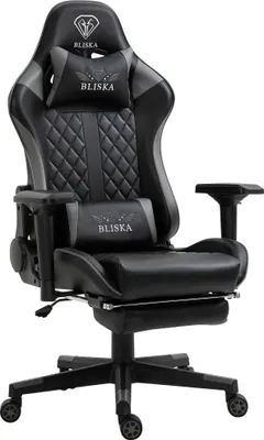 A black and gray gaming chair with a footrest.