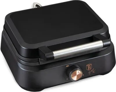 A black waffle maker with rose gold accents is shown from a slightly elevated front-left angle on a white background.