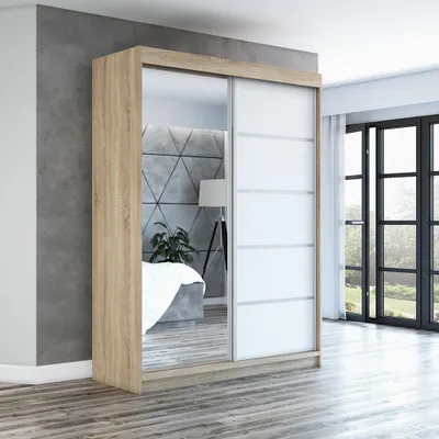 A modern bedroom with a sliding door wardrobe.