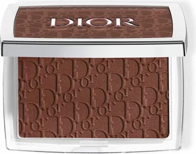A close-up, top-down view of a Dior bronzer compact.