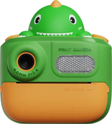 A green dinosaur-shaped instant print camera with orange accents, shown from the front against a white background.