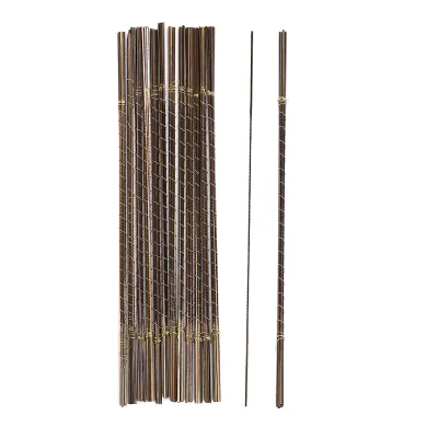 A bundle of thin metal rods with spiral patterns, standing upright.