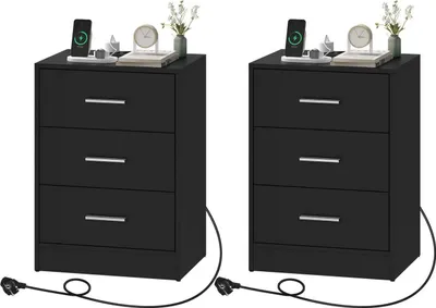 Two black nightstands are shown side-by-side against a white background. Each nightstand has three drawers and a charging cable extending from the bottom.