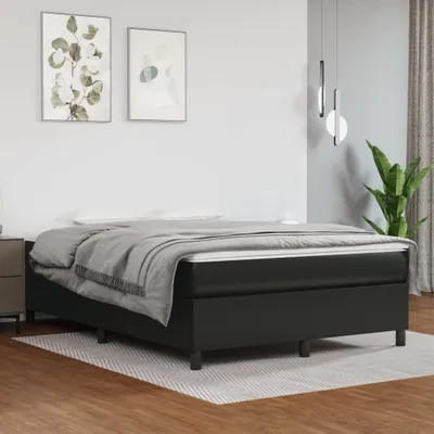 A bedroom scene with a bed, nightstand, and artwork on the wall.
