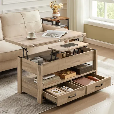 A lift-top coffee table is shown in a living room setting, next to a sofa. The table has multiple storage compartments and drawers, some of which are open.