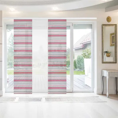 A room with a large sliding glass door covered by panel blinds. The blinds have a striped pattern in light gray and raspberry colors. The room has white flooring and a white console table with a mirror above it.