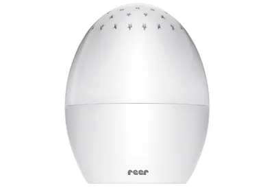 A white egg-shaped night light with small star patterns on the top.