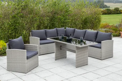 Outdoor patio furniture set with a sectional sofa, armchair, and coffee table.