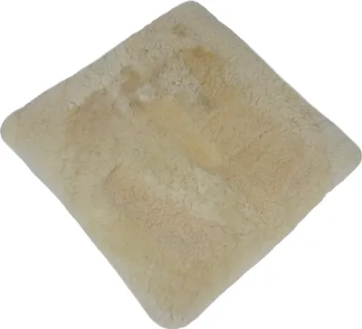 A square, cream-colored sheepskin cushion is shown from a top-down, diagonal angle against a white background.