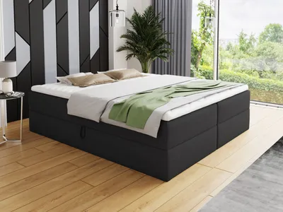A bedroom scene with a bed, nightstand, and a large window overlooking greenery.