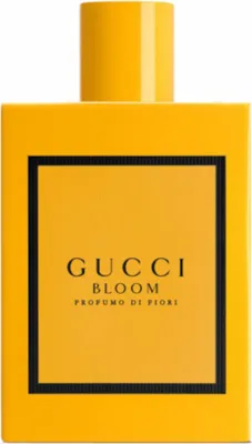 A product shot of a yellow perfume bottle with a black label.