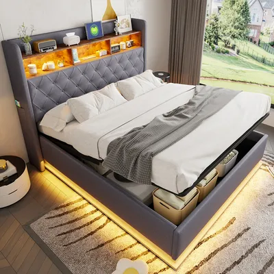 A modern bedroom with a large upholstered bed featuring integrated lighting and storage.