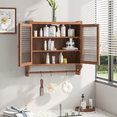 A wooden wall cabinet filled with bathroom products, hanging on a wall above a sink.