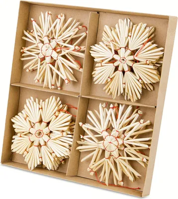 A set of four straw star ornaments in a cardboard box.