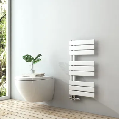 A modern bathroom with a wall-mounted toilet and a white towel radiator.