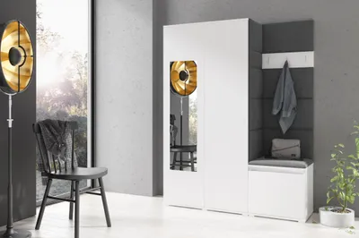 A modern hallway with a white wardrobe, a padded bench, and a decorative floor lamp.