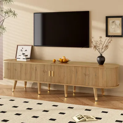 A TV stand with a TV mounted above it in a living room setting.