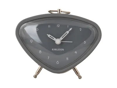 A close-up studio shot of a gray alarm clock.