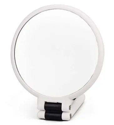 A white, round, foldable hand mirror with a black hinge is shown against a white background.