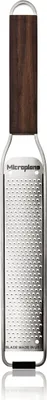 A close-up studio shot of a grater with a wooden handle.