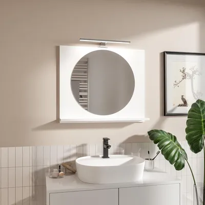 A modern bathroom vanity with a white sink, black faucet, and a white framed mirror with integrated lighting.