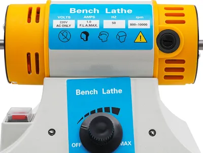 Close-up of a bench lathe with its control panel and motor housing visible.