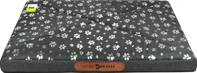 A dog bed with a paw print pattern.