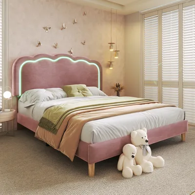 A bedroom scene with a pink upholstered bed, bedding, and decorative elements.