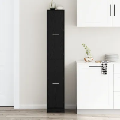 A tall, narrow black cabinet stands in a kitchen setting next to white cabinets and a countertop.