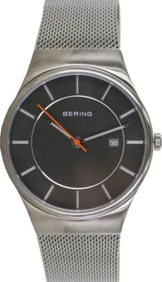 A close-up studio shot of a Bering men's watch with a mesh band.