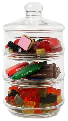 A stacked glass candy jar filled with various types of candies.