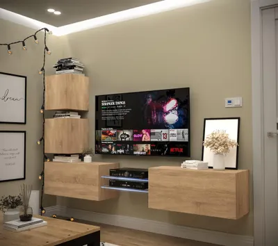 A modern living room setup featuring a wall-mounted entertainment unit with a television, media console, and shelving.