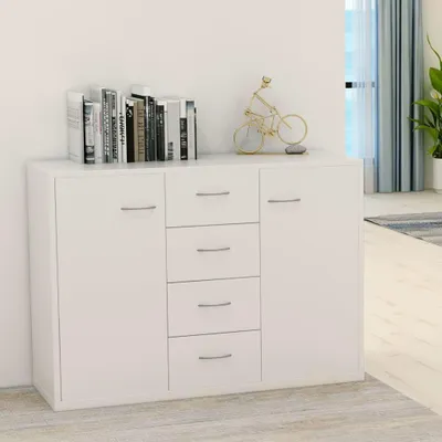 A white sideboard with books and a decorative bicycle on top, placed against a white wall with blue curtains in the background.