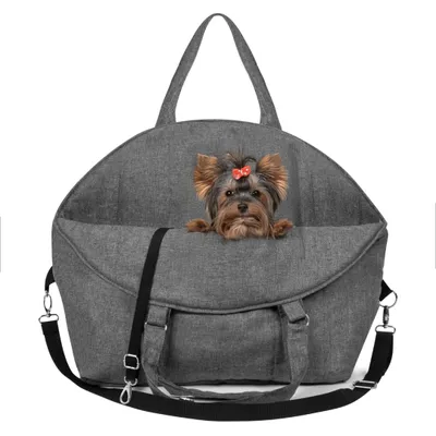 A small dog with a red bow is peeking out of a gray pet carrier bag.
