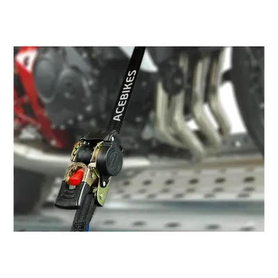 A close-up of a ratchet tie-down strap attached to a motorcycle.