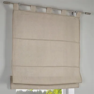 A close-up view of a beige linen Roman blind hanging from a metal curtain rod.