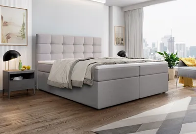 A bedroom scene with a bed, nightstand, and a window overlooking a city skyline.