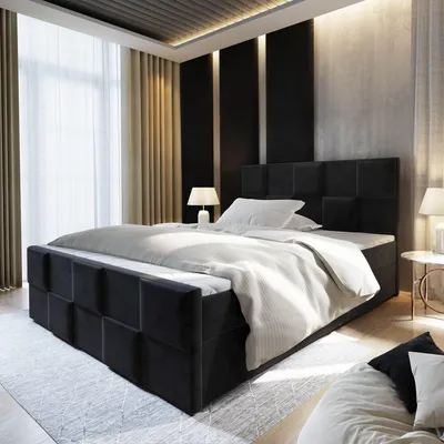 A bedroom scene with a large black upholstered bed as the focal point.