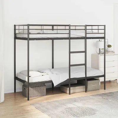 A metal bunk bed with mattresses and storage bins underneath, set against a white wall.