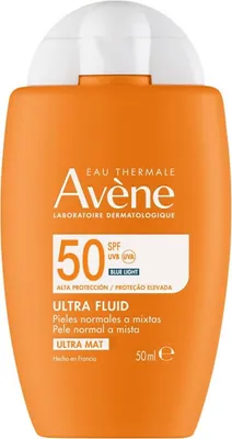 A product shot of an orange sunscreen bottle with white text and a white cap.