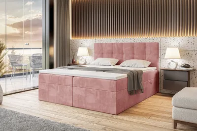 A bedroom scene with a pink upholstered bed, bedside tables, and a balcony view.