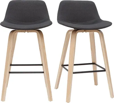 Two dark gray fabric bar stools with light wood legs are shown against a white background.