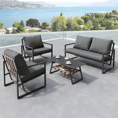 A patio furniture set is arranged on a rooftop terrace overlooking a lake and distant hills.