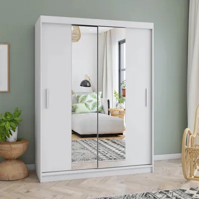 A white sliding door wardrobe with mirrored doors is shown in a room with a green wall.