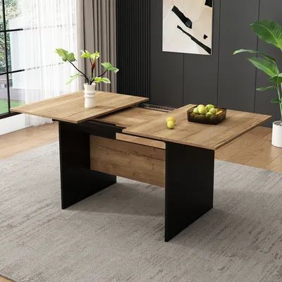 A dining table with an extension leaf, set in a modern dining room with a rug, curtains, and artwork.