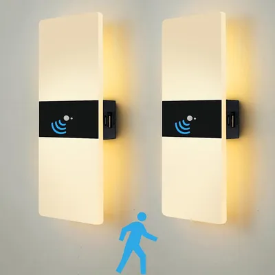 Two wall lights with motion sensor icons and a blue silhouette of a person walking.