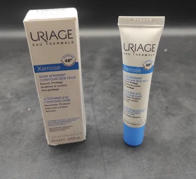 A box and a tube of Uriage Xémose Soothing Eye Contour Care are displayed on a gray surface.