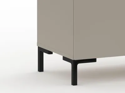 A close-up view of the bottom section of a cabinet, showing its legs.