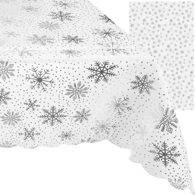 A white tablecloth with a silver snowflake pattern is shown diagonally, with a smaller swatch of the pattern in the upper right corner.